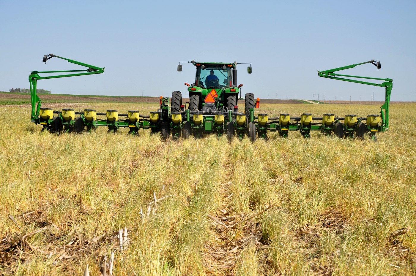 A no-till planter working through terminated cereal rye in north-central Iowa